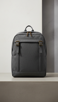 Urban Pewter Slim Laptop Backpack, backpack standing upright on a matte concrete plinth or architectural bench. Background...